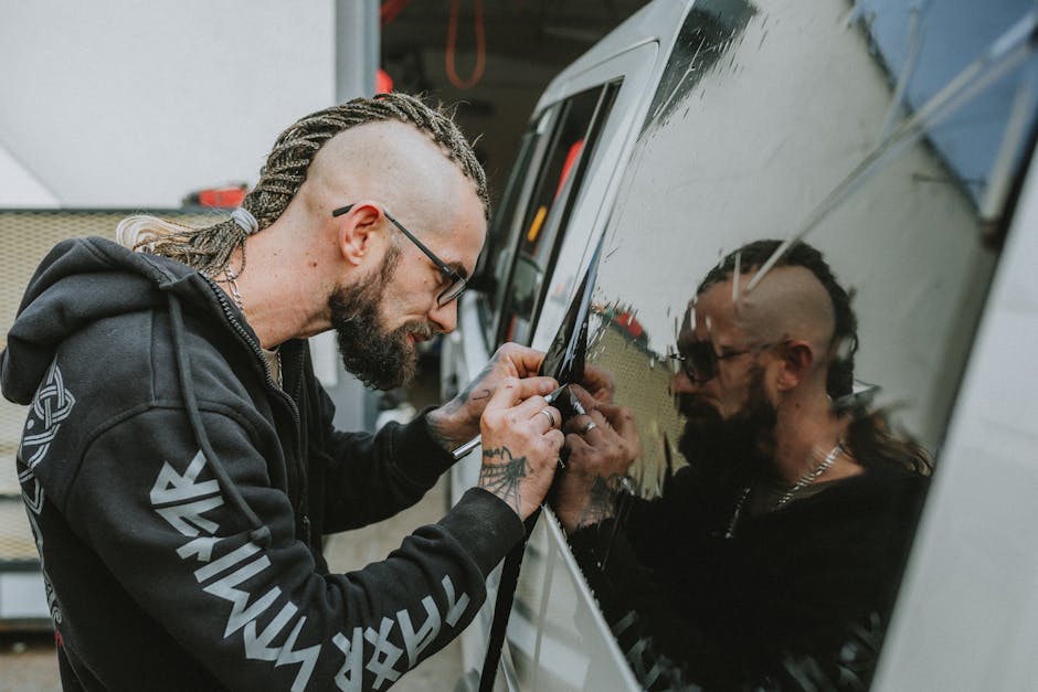 Technician installing new auto glass
